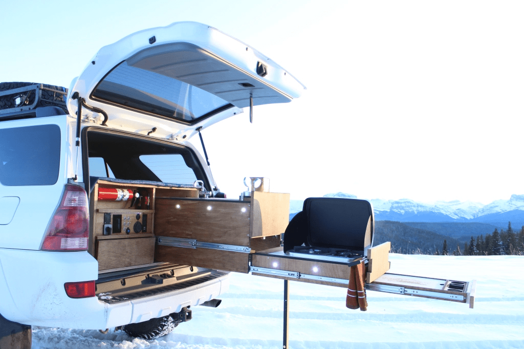A camping set up using only the ruck space of a Toyota 4Runner. This design used a triple locking slide system.